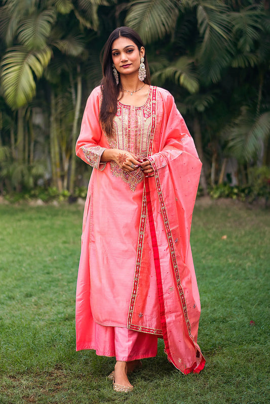 Indian model in a peach chanderi kurta with zardozi work, paired with a matching peach dupatta and palazzo.
