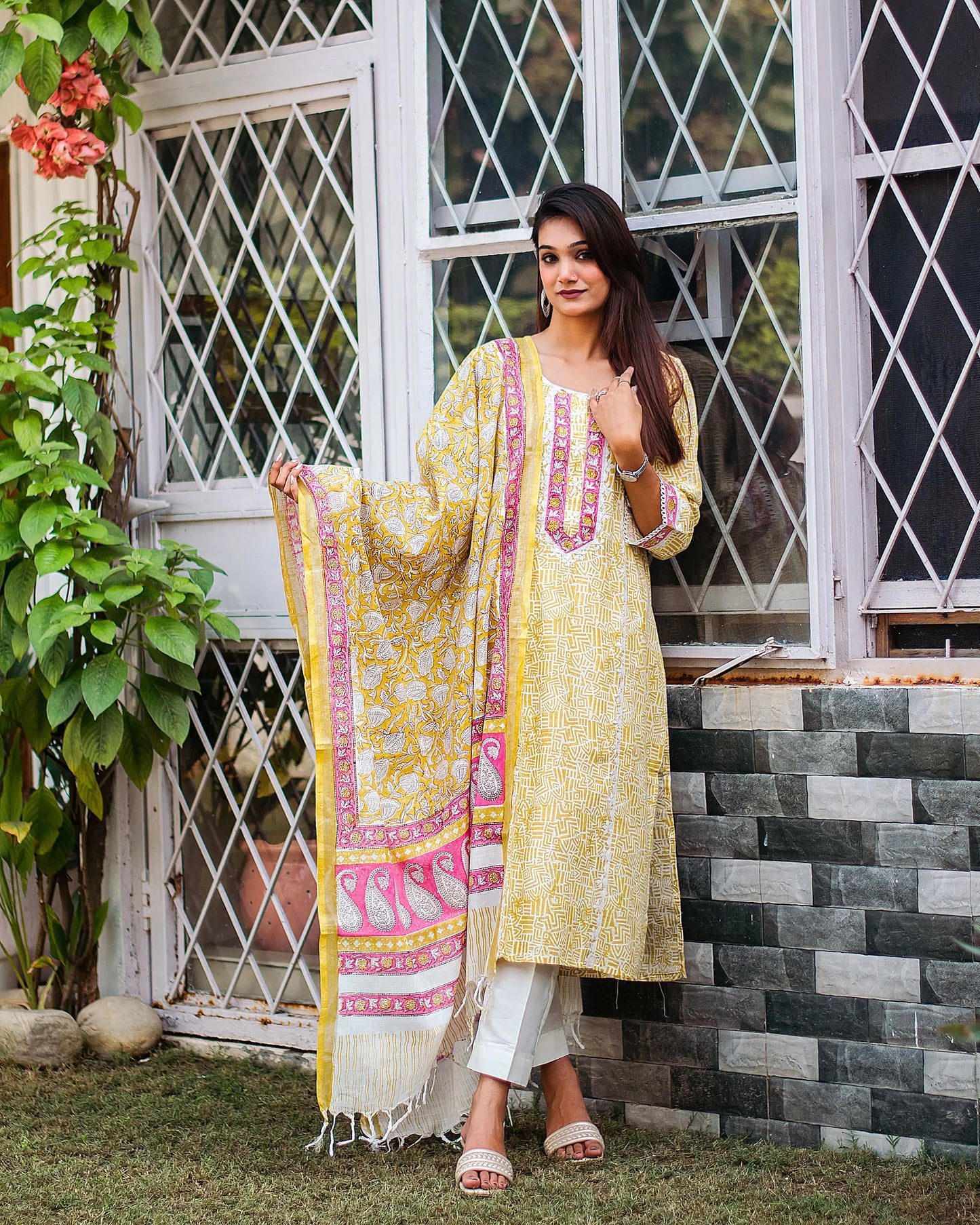 Alternate front view (full suit, top to bottom): Model wearing a lemon yellow linen kurta, off-white trousers, and printed dupatta, in an alternate front-facing pose.