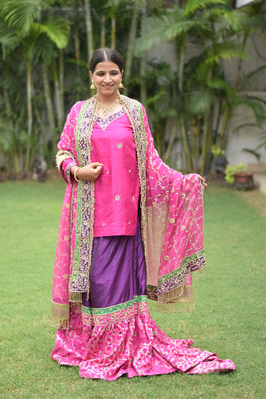 Exquisite bridal ensemble showcasing Magenta & Purple Bridal Kamkhab Farshi Gharara Set With Zardozi Work