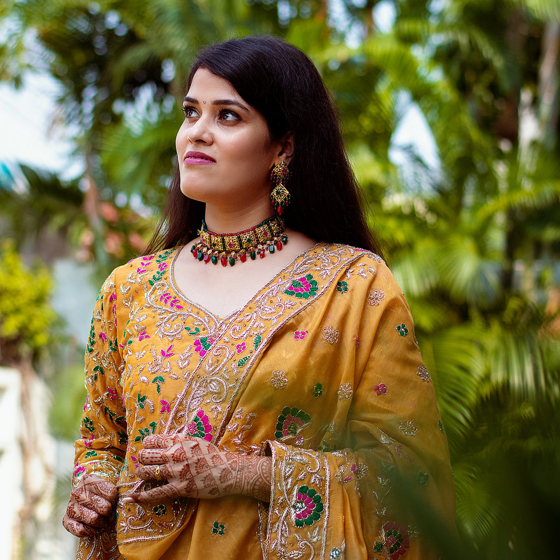 Indian women wearing hand embroidered zardozi work kurta set
