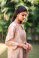 Upper half right side view of a model wearing the beige floral print kurta set, featuring a beige floral print chanderi angrakha, matching palazzo