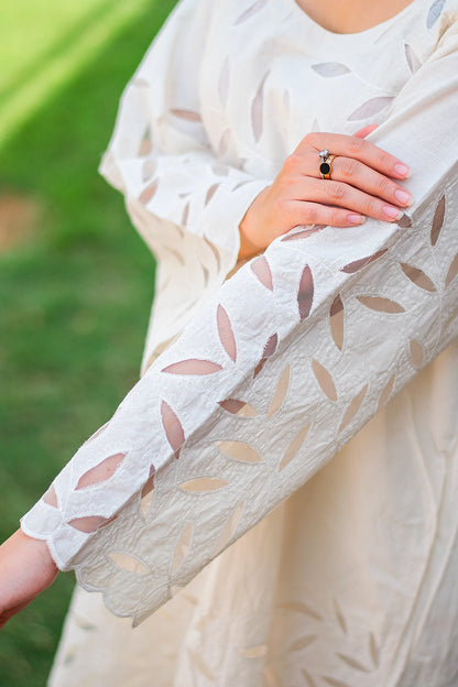 Detailed view of the floral cutwork embroidery on the sleeve of the off-white kurta.