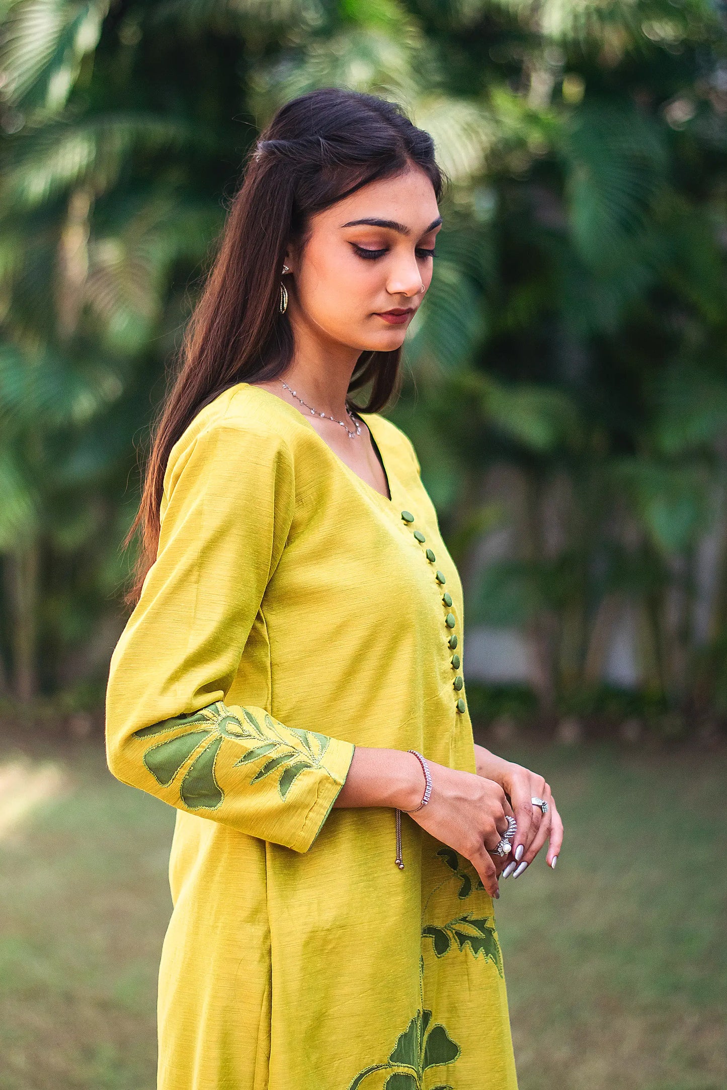 Right side view of a model wearing the cutwork kurta set, highlighting the straight fit kurta's elegant silhouette