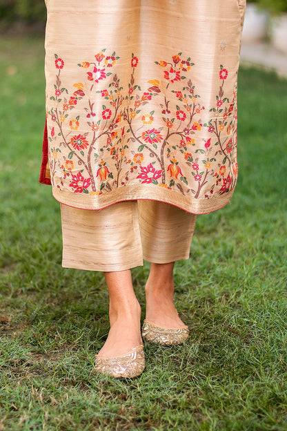 Close-up of the beige silk trousers paired with the beige kurta, worn by an Indian model.