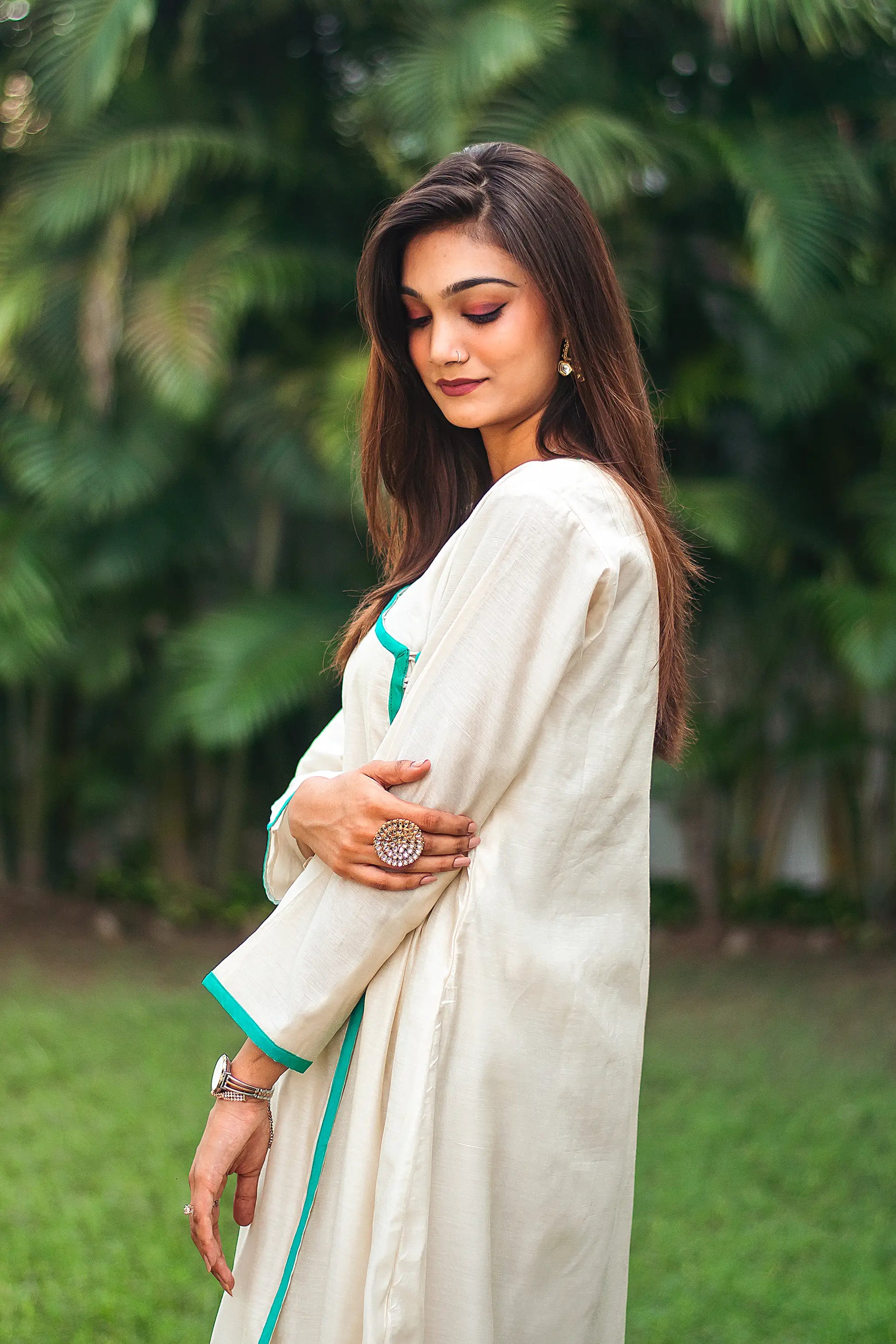 Upper left side view of a model wearing the beige chanderi angrakha set, highlighting the timeless angrakha silhouette