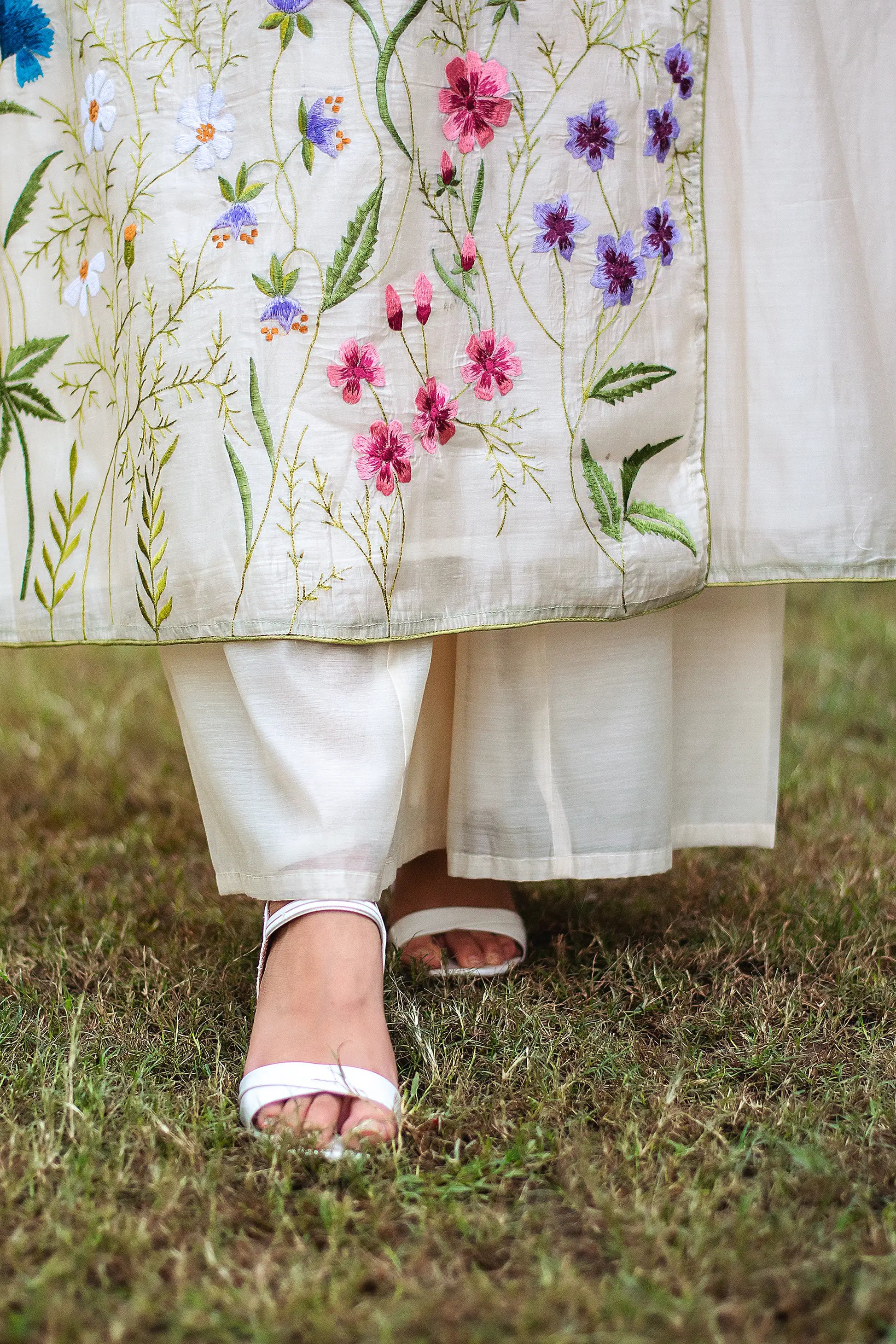 Close-up of the off-white chanderi palazzo paired with the angrakha kurta, worn by an Indian model.