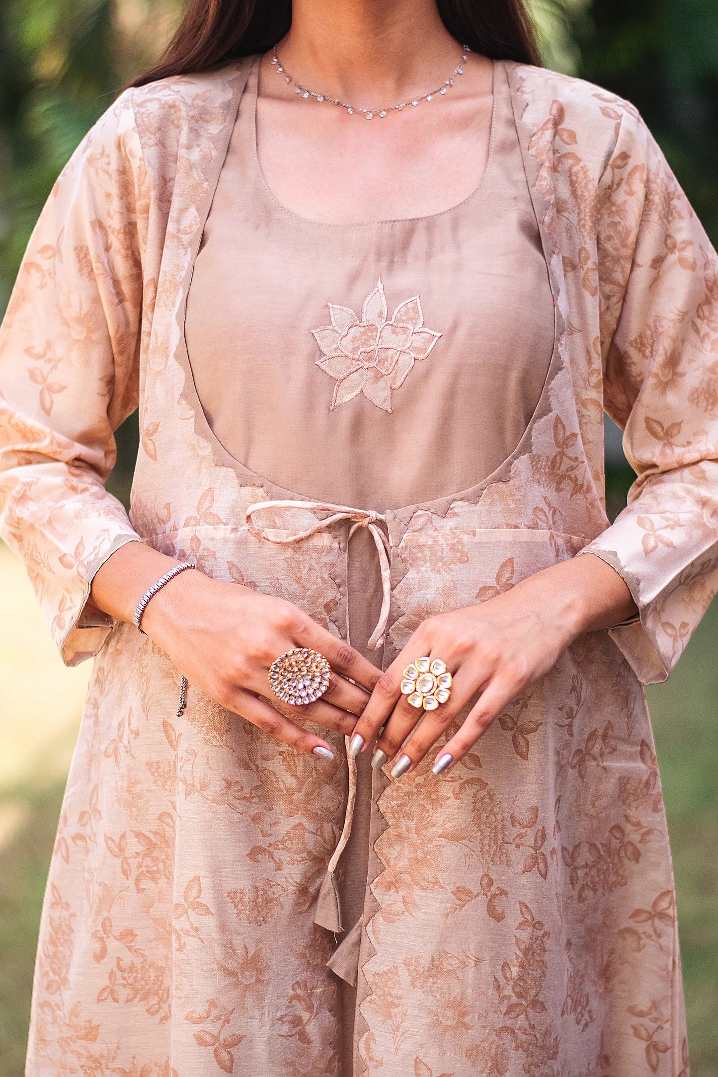 Detailed shot of the kikri work and patchwork flower motif on the floral print kurta, as styled by the model