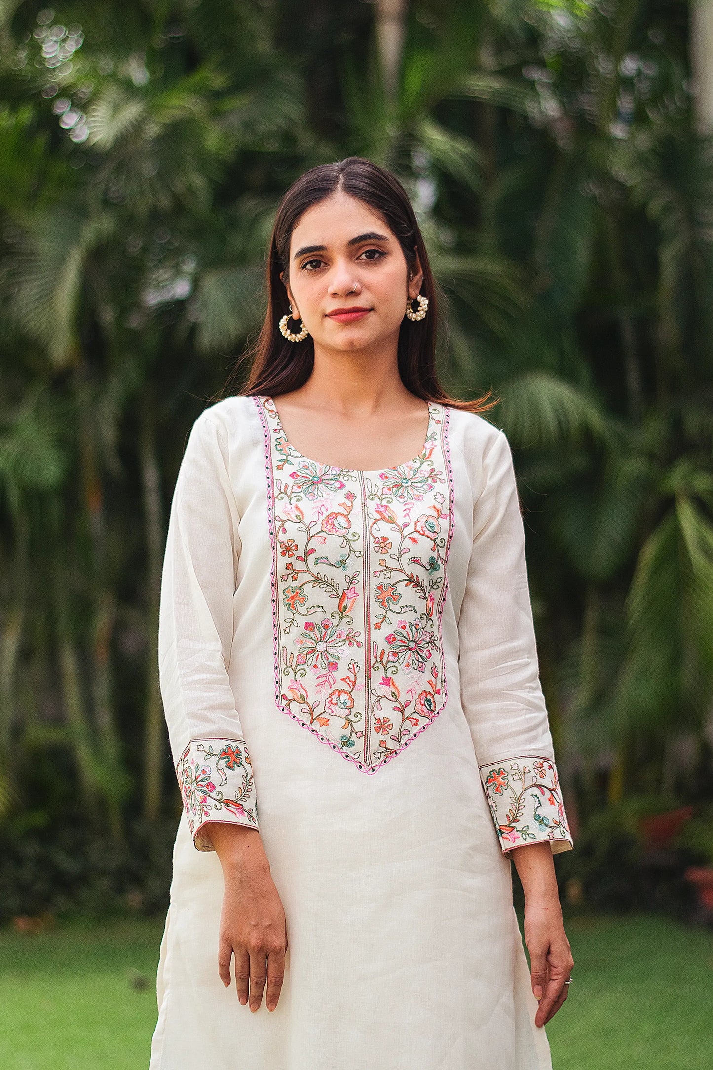 Close-up of the model wearing an off-white kurta, focusing on the Kashmiri embroidery on the yoke