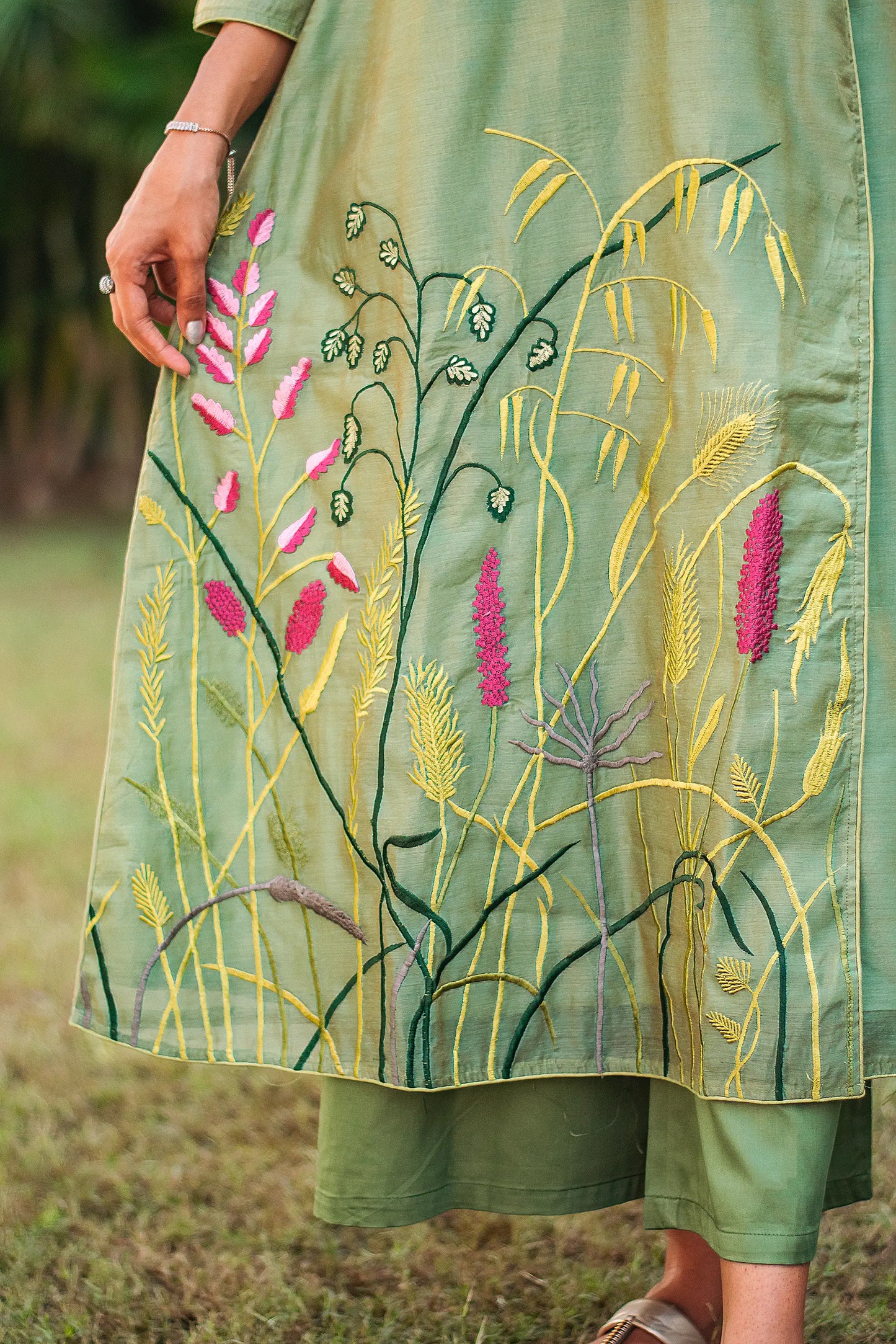 Detailed shot of the multicolour floral embroidery on the green kurta as styled by the model