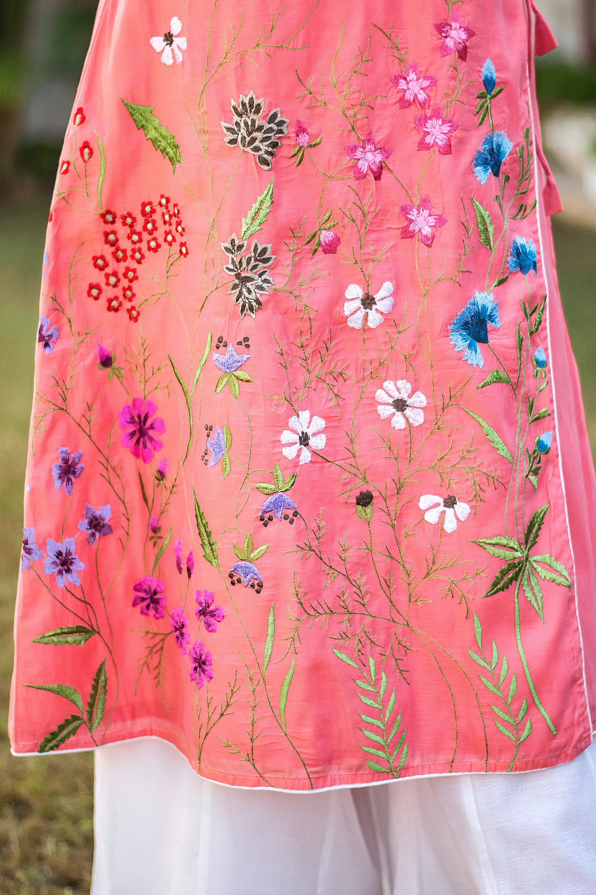 Detailed shot of the multicolour floral embroidery on the pink kurta as styled by the mode