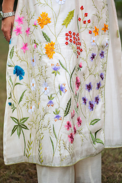 Zoomed-in view highlighting the colorful resham floral motifs on the off-white angrakha kurta.