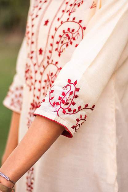 Close-up of the maroon applique work on the sleeve cuff of the beige chanderi kurta.