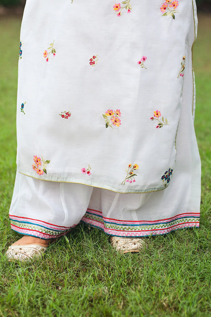 Close-up of the white chanderi palazzo with embroidery at the hem.