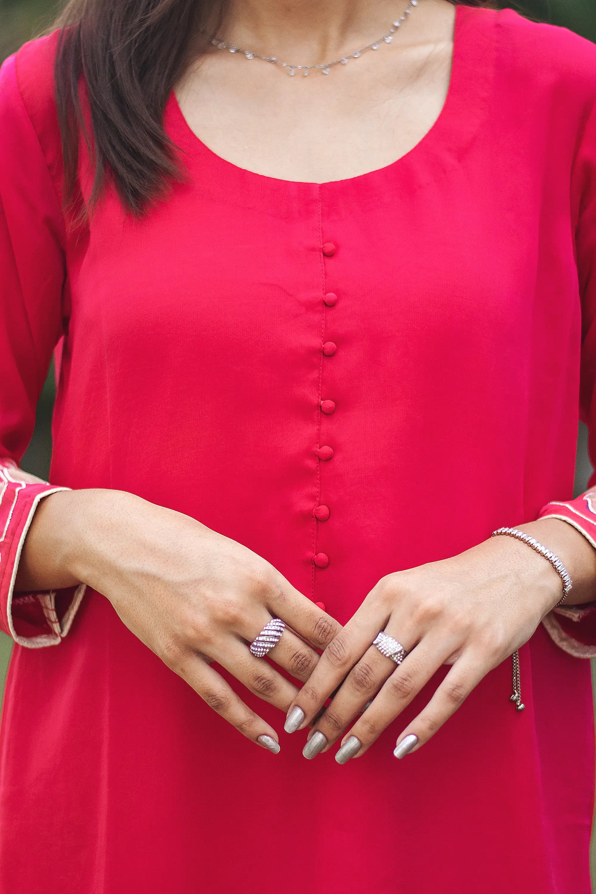 Close-up of the yoke of a red organza kurta.