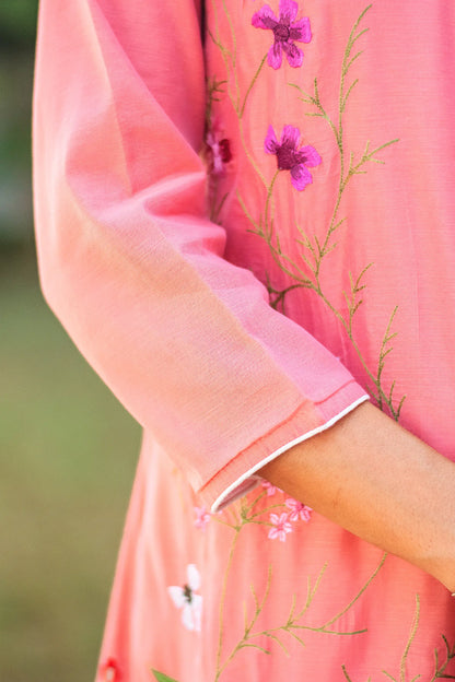 Close-up of the three-quarter length sleeves of the pink angrakha.