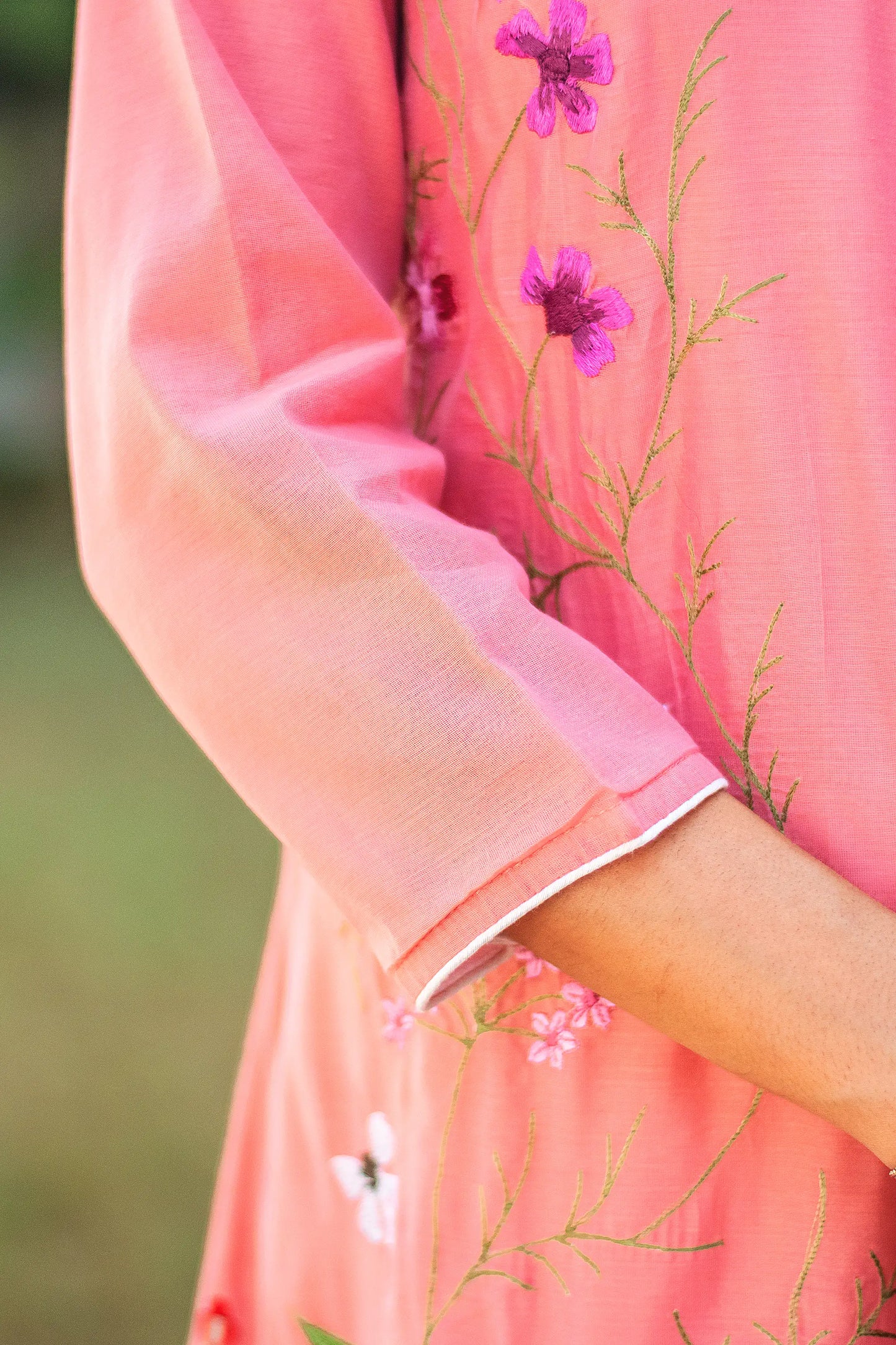 Close-up of the three-quarter length sleeves of the pink angrakha.