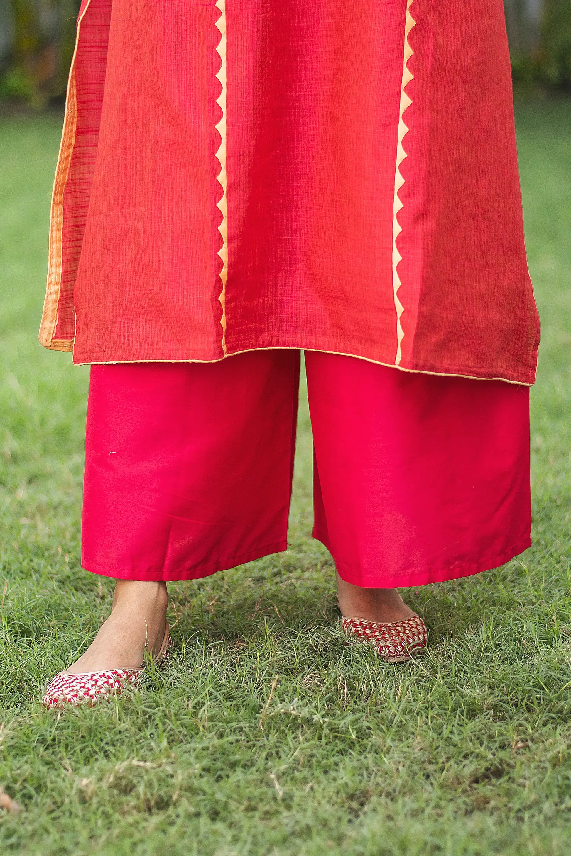 Close-up of the red tussar palazzo trousers, paired with the red jute silk kurta.