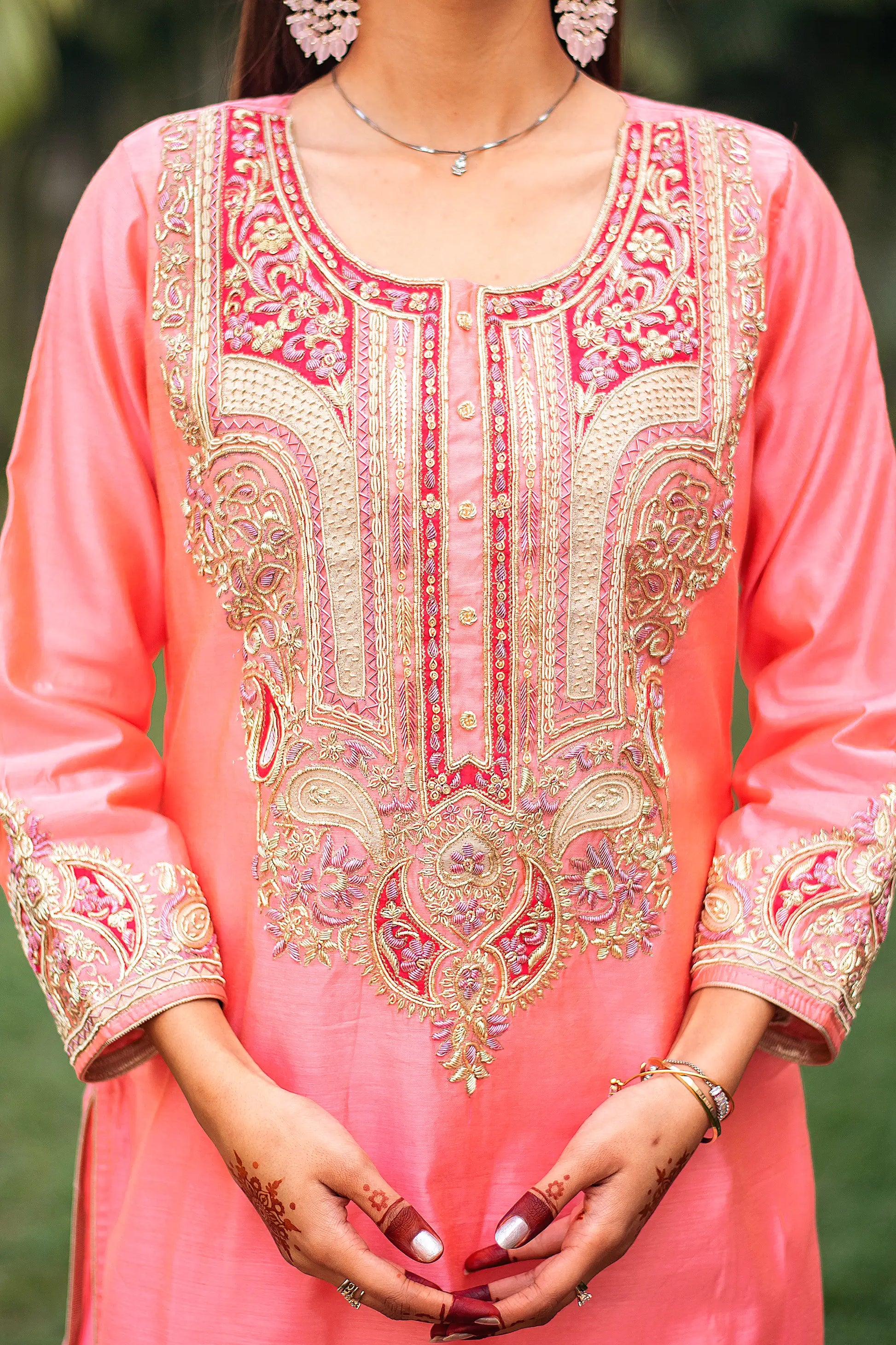 Close-up of the dense zardozi embroidery on the yoke of the peach chanderi kurta.