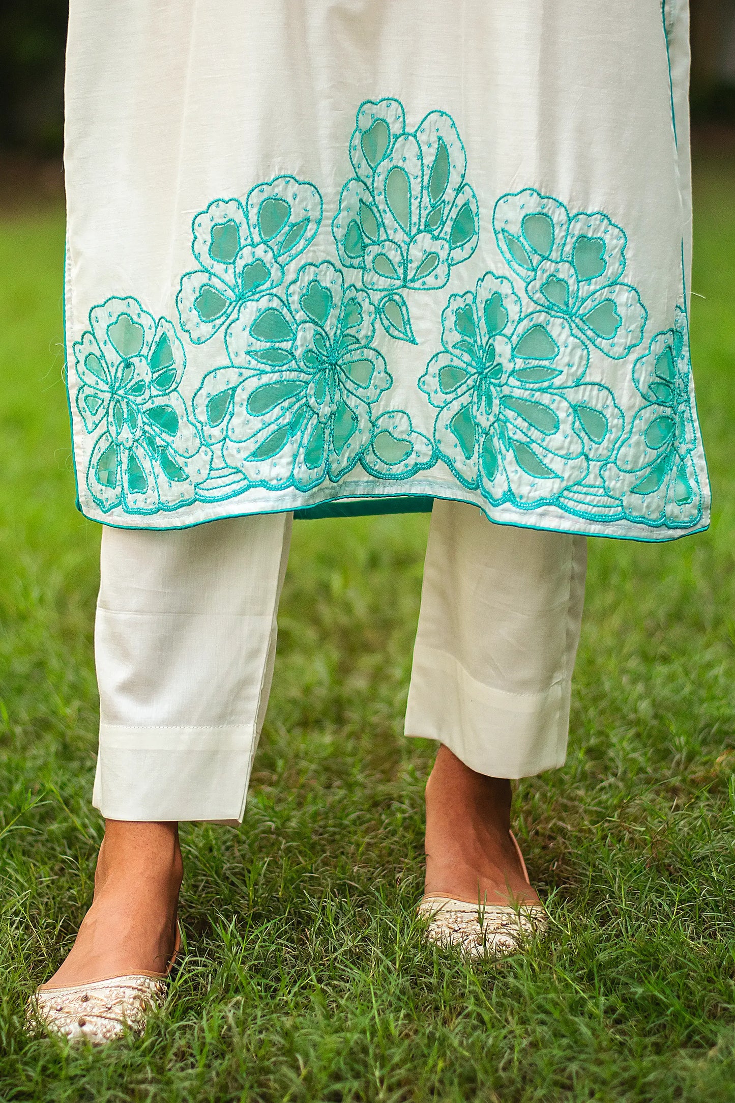 Detailed shot of the cyan green floral cutwork and sequins on the Chanderi kurta and dupatta, as styled by the model