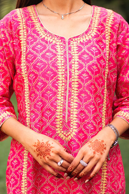 Close-up of the beige applique motifs on the yoke of the magenta foil-printed chanderi kurta.