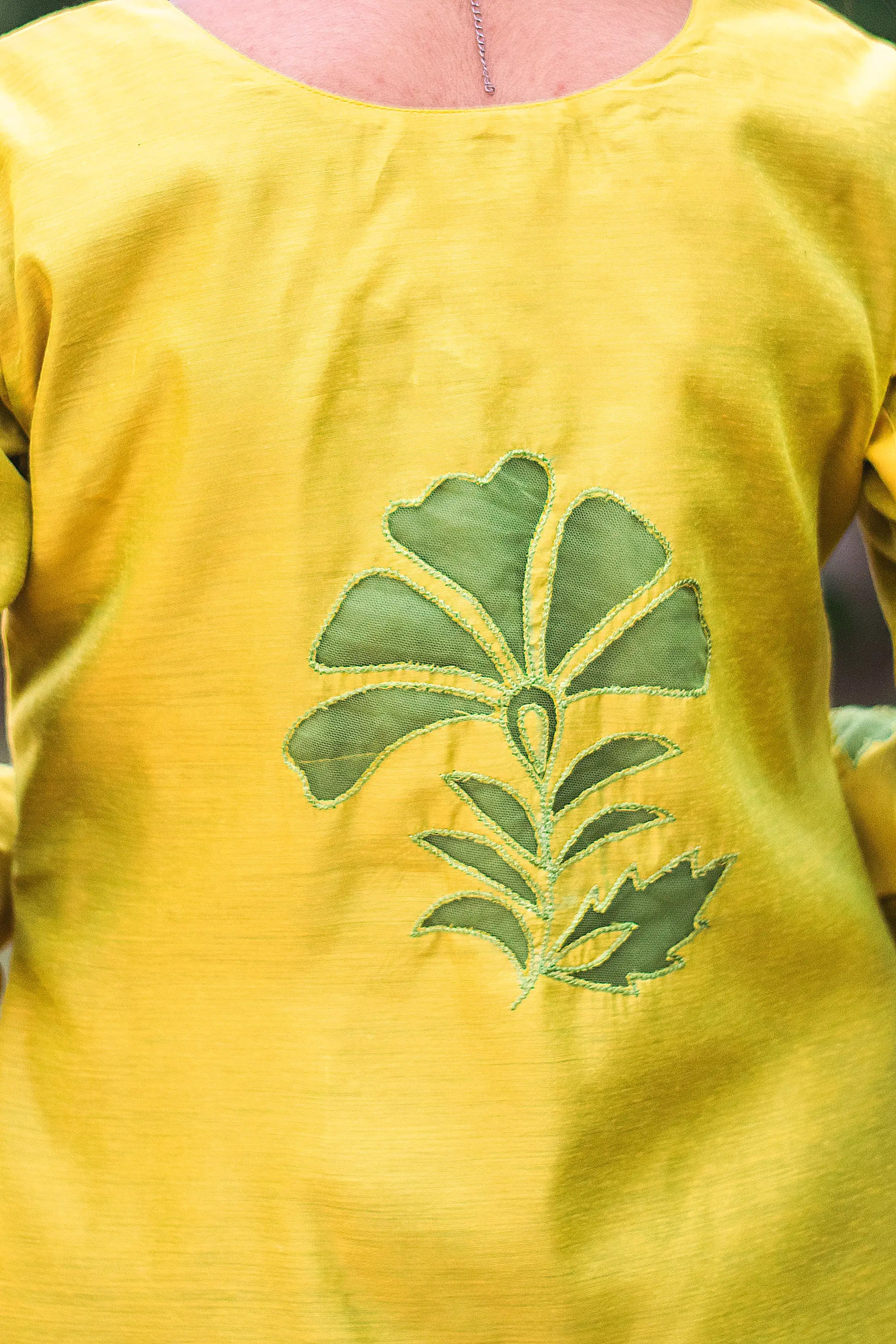 Upper back view of a model wearing the cutwork kurta set, showcasing the cutwork flower at the back