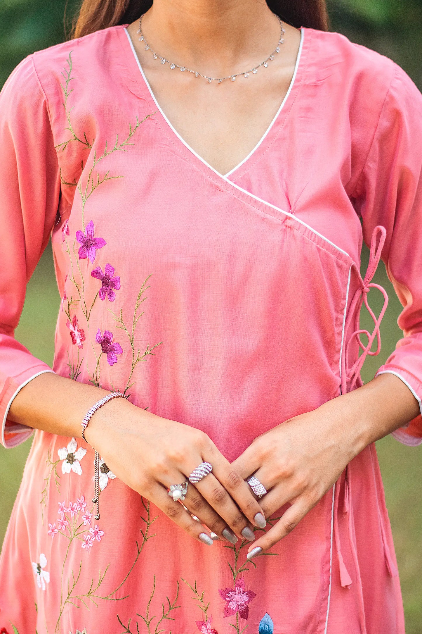 Upper front view of a model wearing the pink chanderi kurta set, featuring a pink chanderi angrakha.