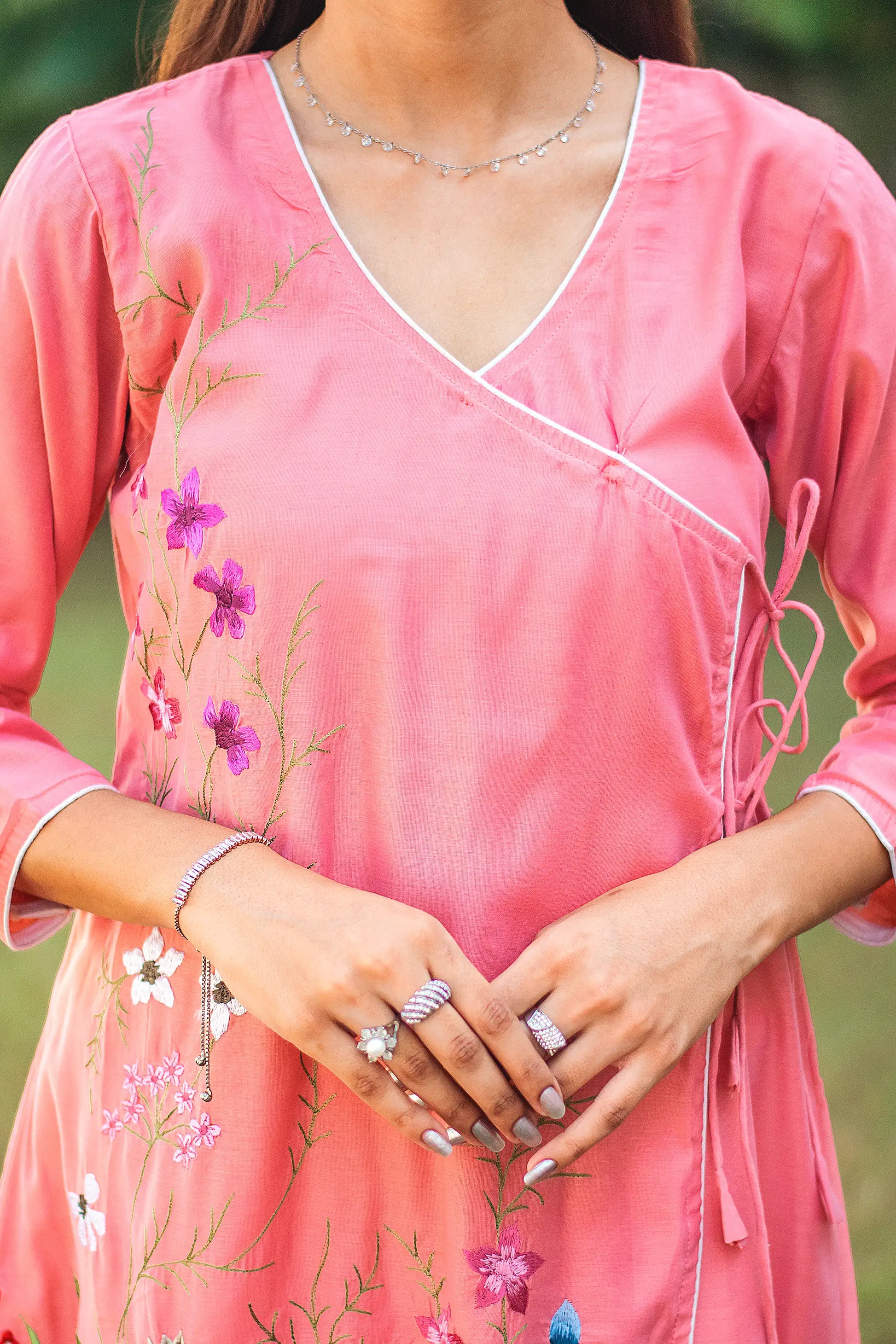 Upper front view of a model wearing the pink chanderi kurta set, featuring a pink chanderi angrakha.