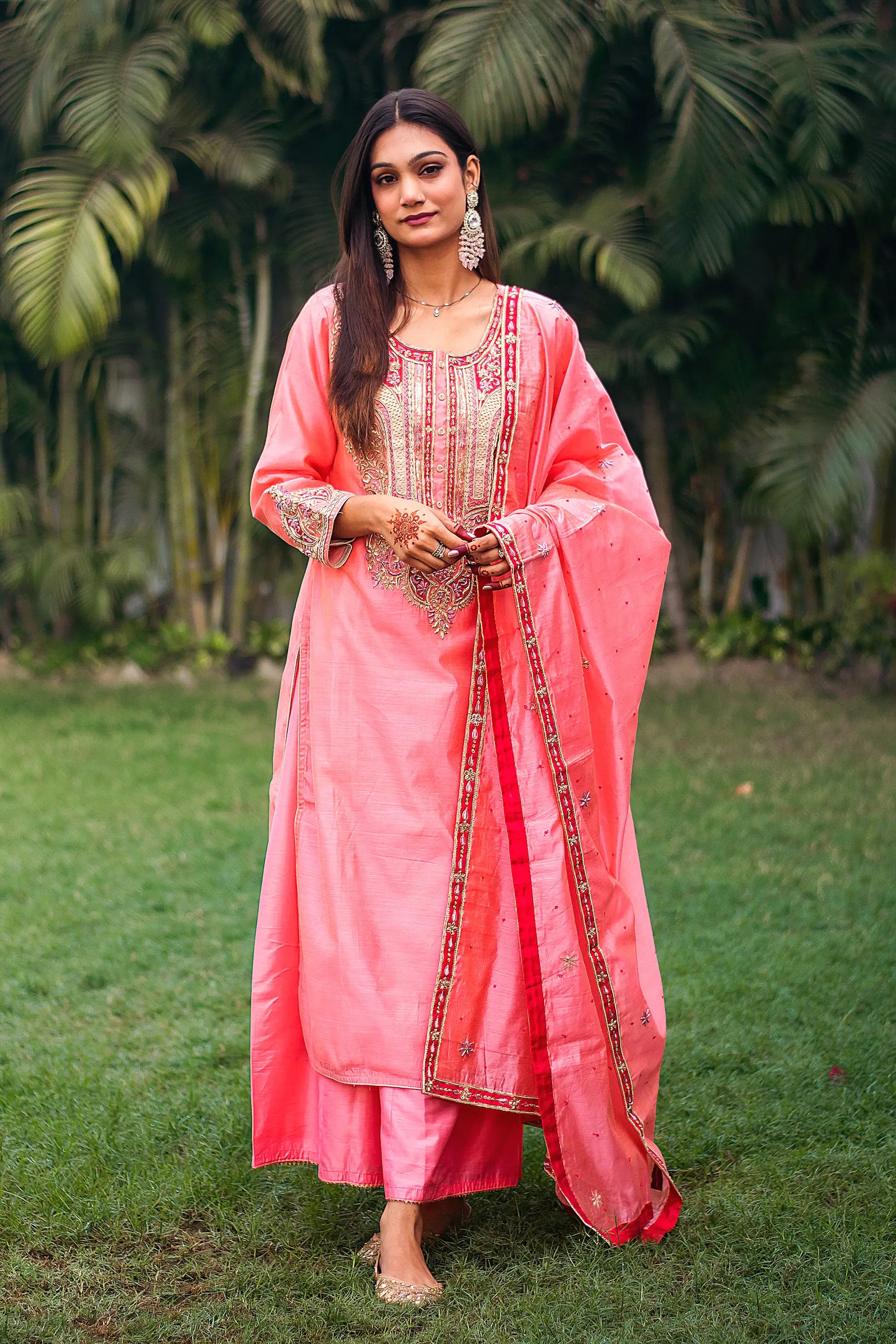  Indian model in a peach chanderi kurta with zardozi work, paired with a matching peach dupatta and palazzo.