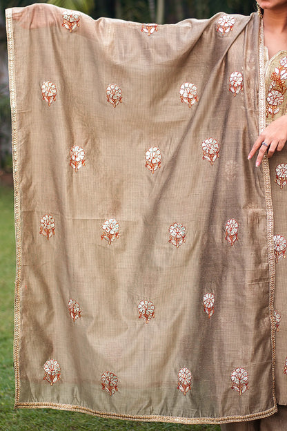 Indian model holding a beige Chanderi dupatta with golden gota patti motifs and lace detailing.