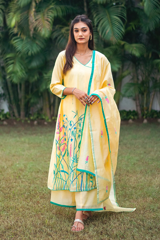  Indian model in a yellow angrakha kurta with pink and teal resham embroidery, paired with a matching dupatta and palazzo.