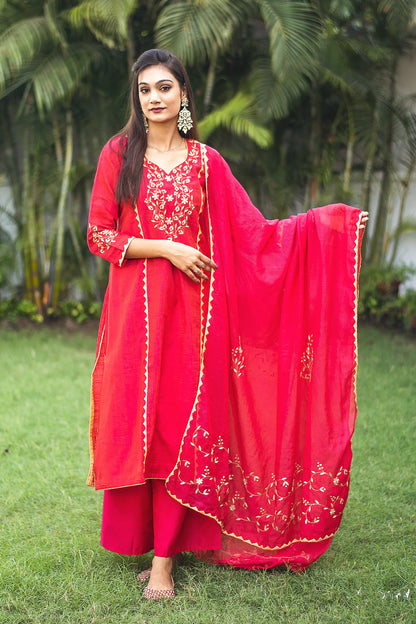 Indian model in a red jute silk kurta and chanderi dupatta with beige applique work, paired with a matching palazzo.