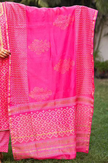 Indian model holding a magenta chanderi dupatta with foil-printed floral motifs and chevron design along the borders