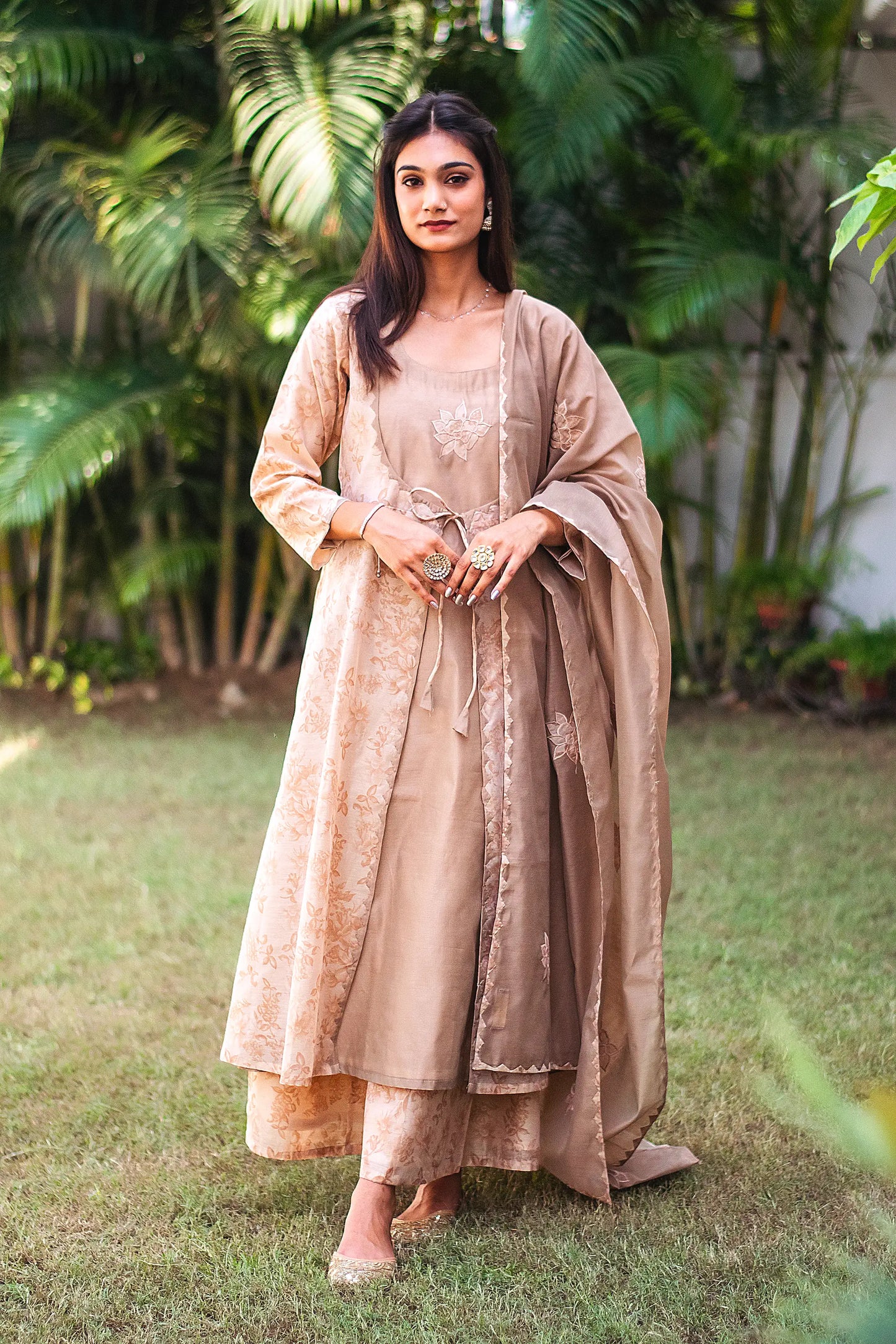 Model wearing the beige floral print kurta set in an elegant pose, showcasing the ensemble's style