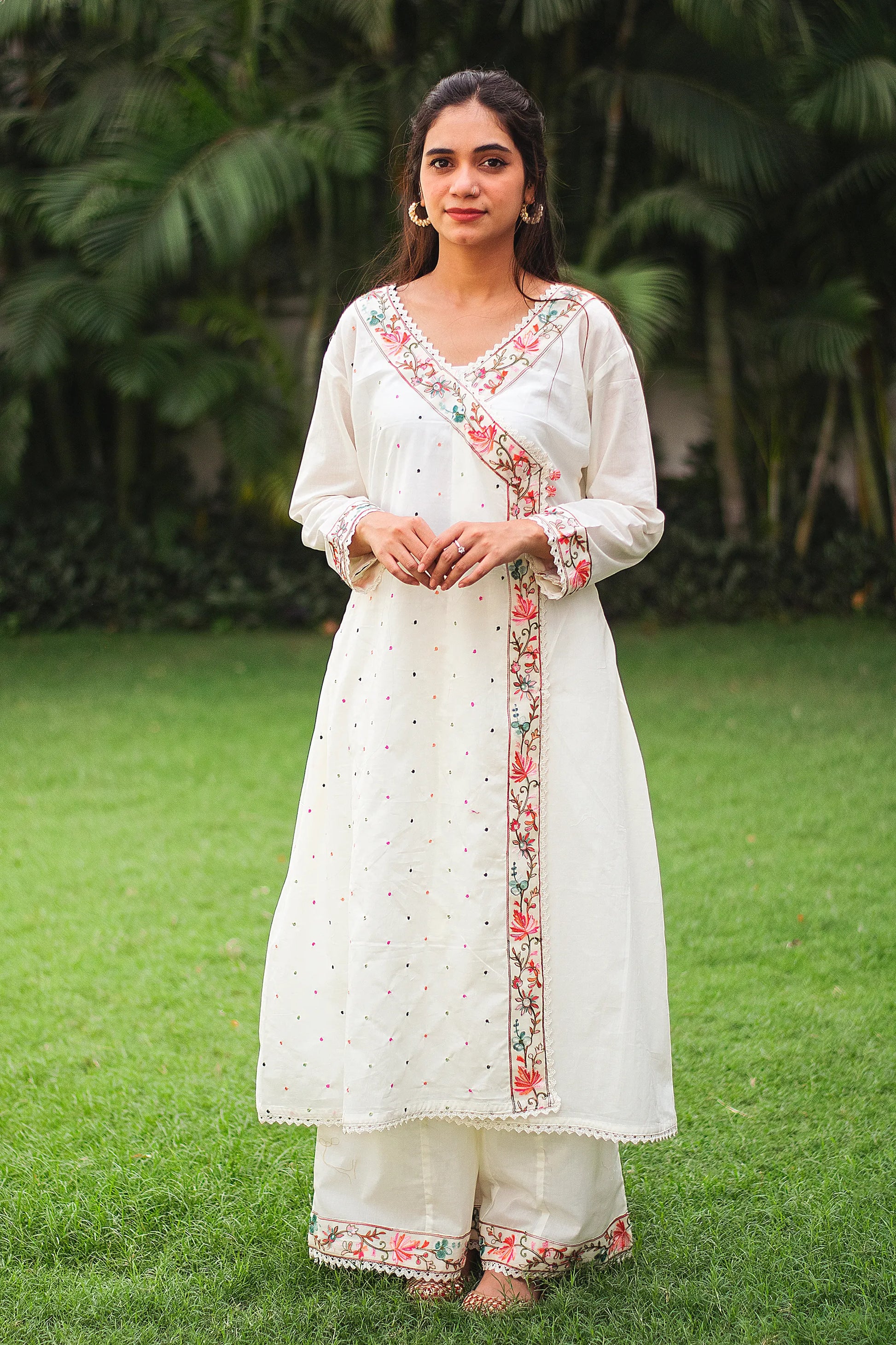 An Indian Girl wearing off-white colored Angarkha dress