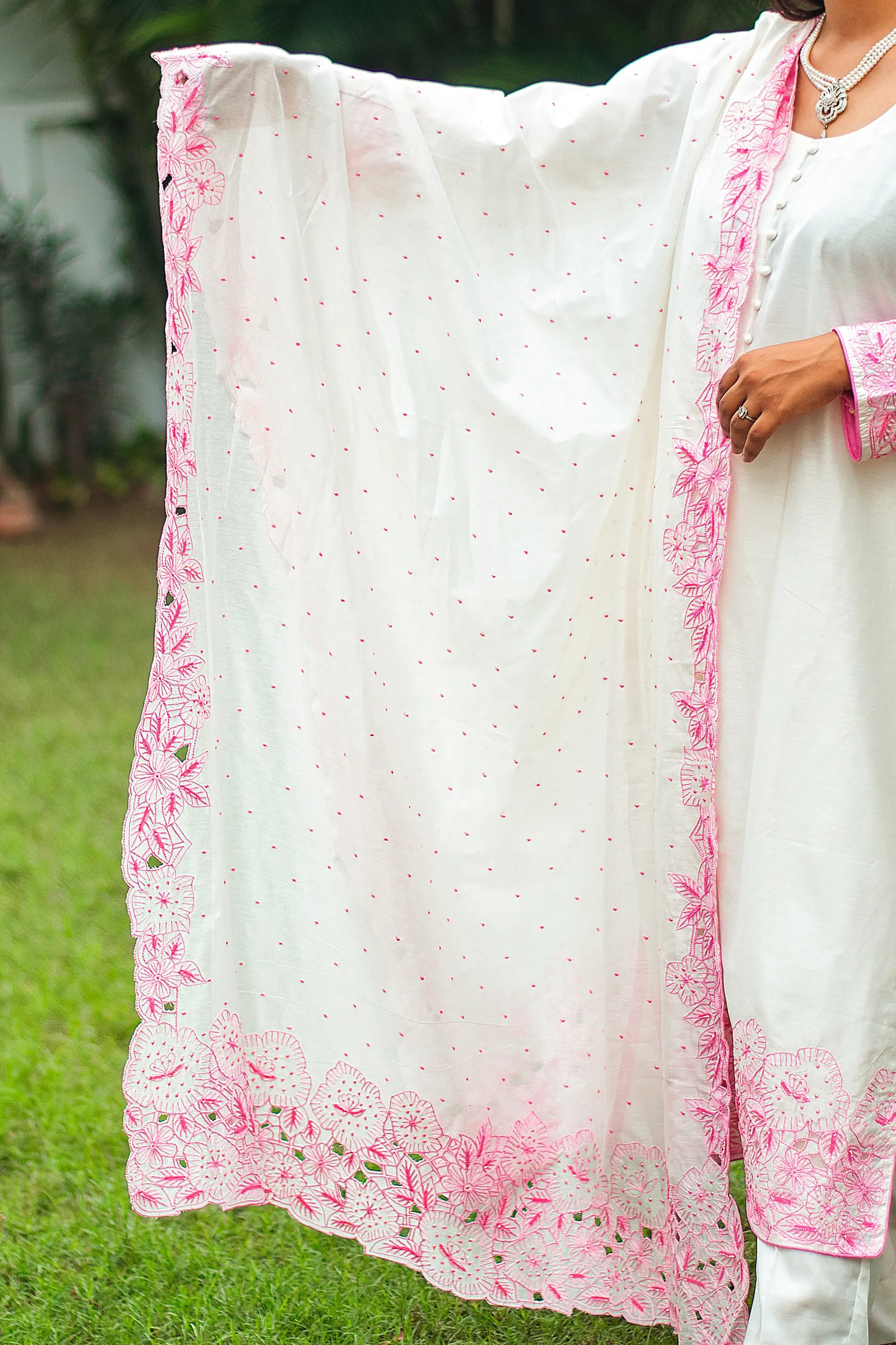 Indian model displaying the off-white chanderi dupatta with pink floral cutwork and scattered pink sequins.