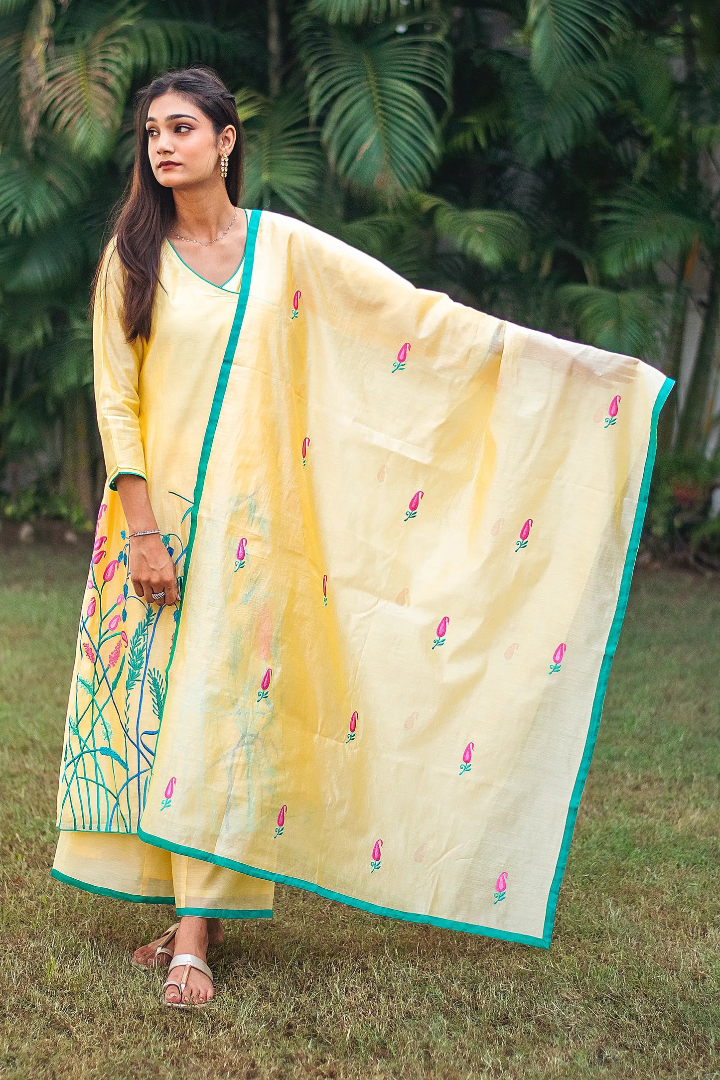  Indian model in a yellow angrakha kurta set, featuring vibrant floral resham work