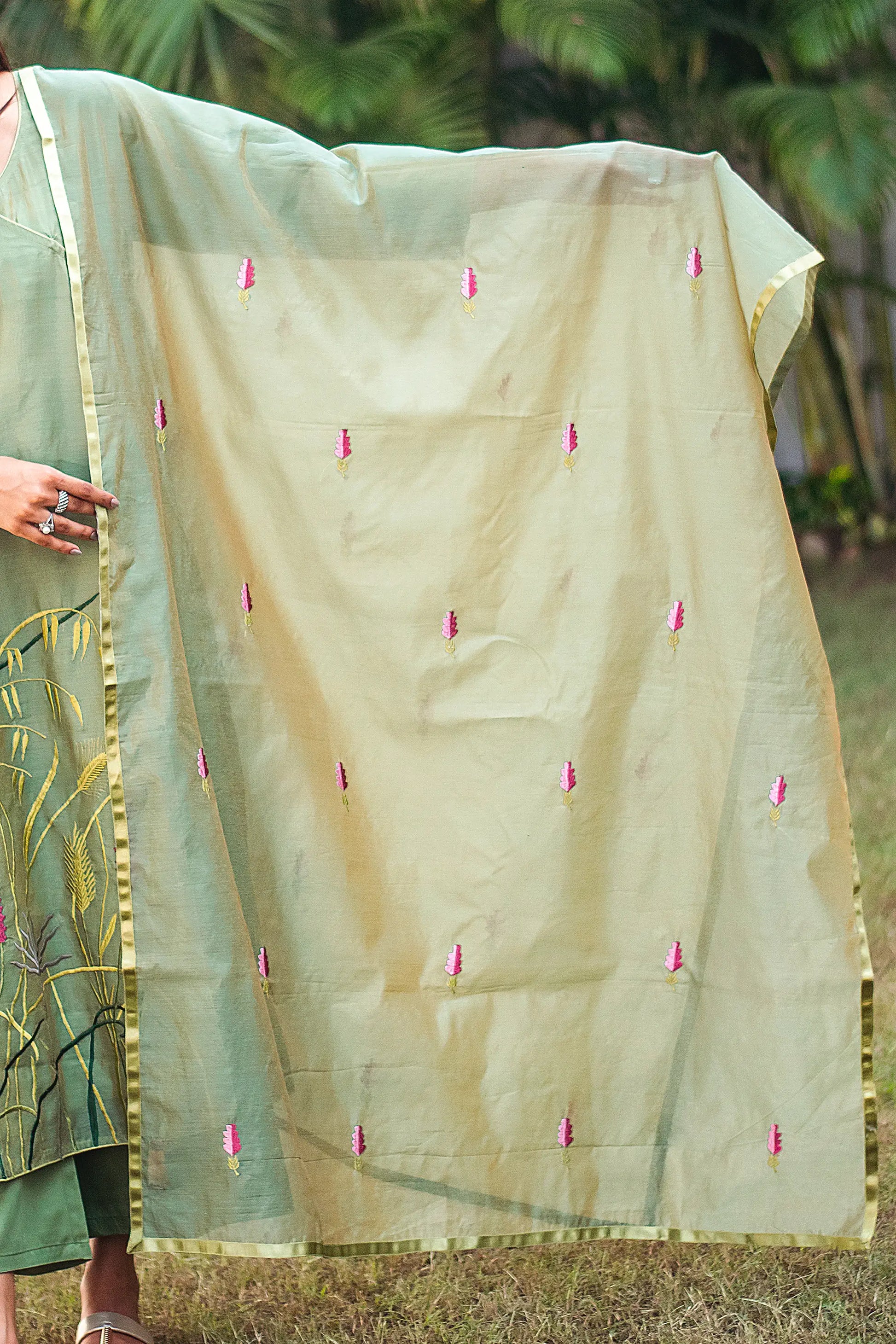 Detail of the green chanderi dupatta embellished with embroidered flowers, as styled by the model.