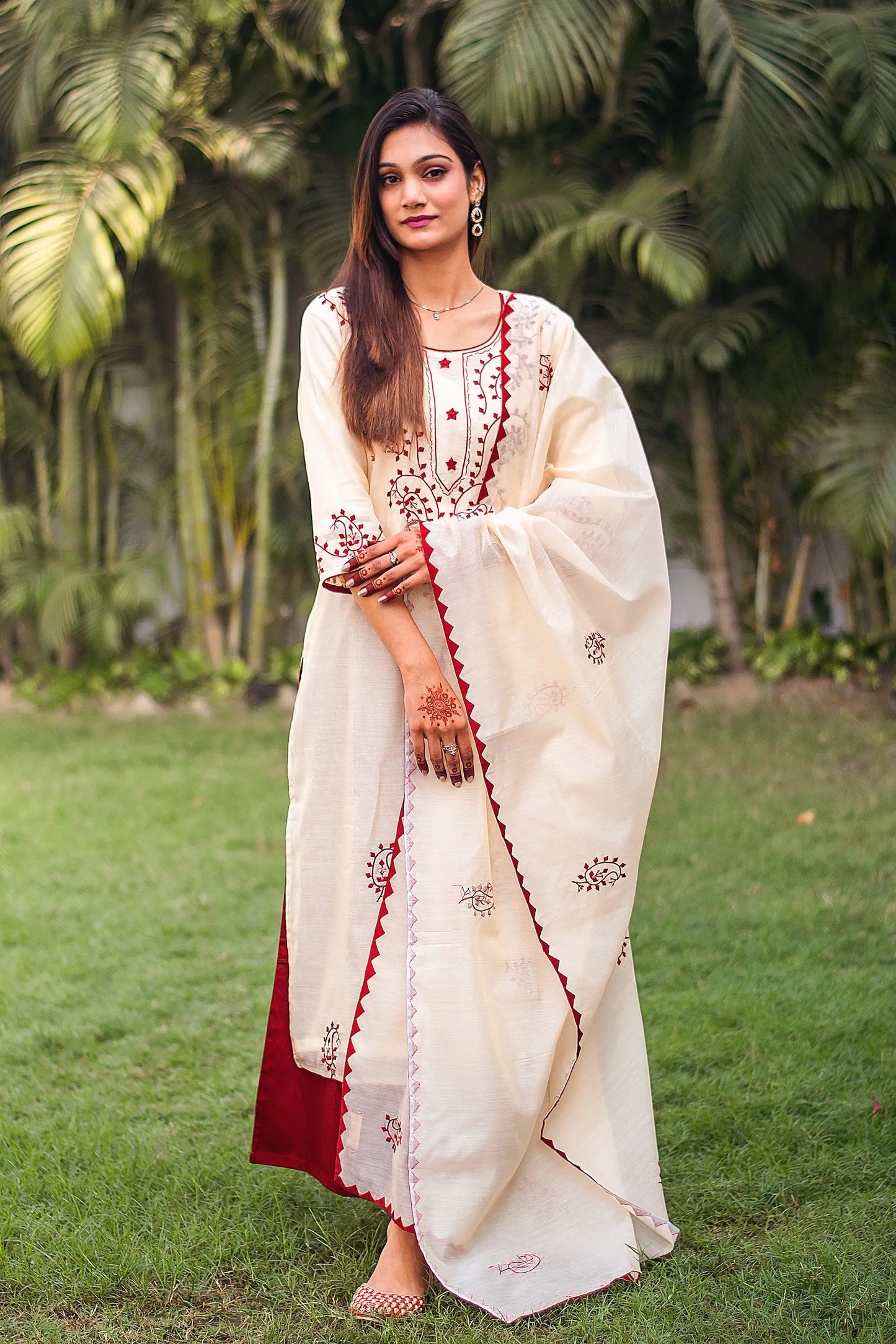 Indian model in a beige chanderi kurta and dupatta with maroon applique work, paired with a contrasting maroon palazzo.