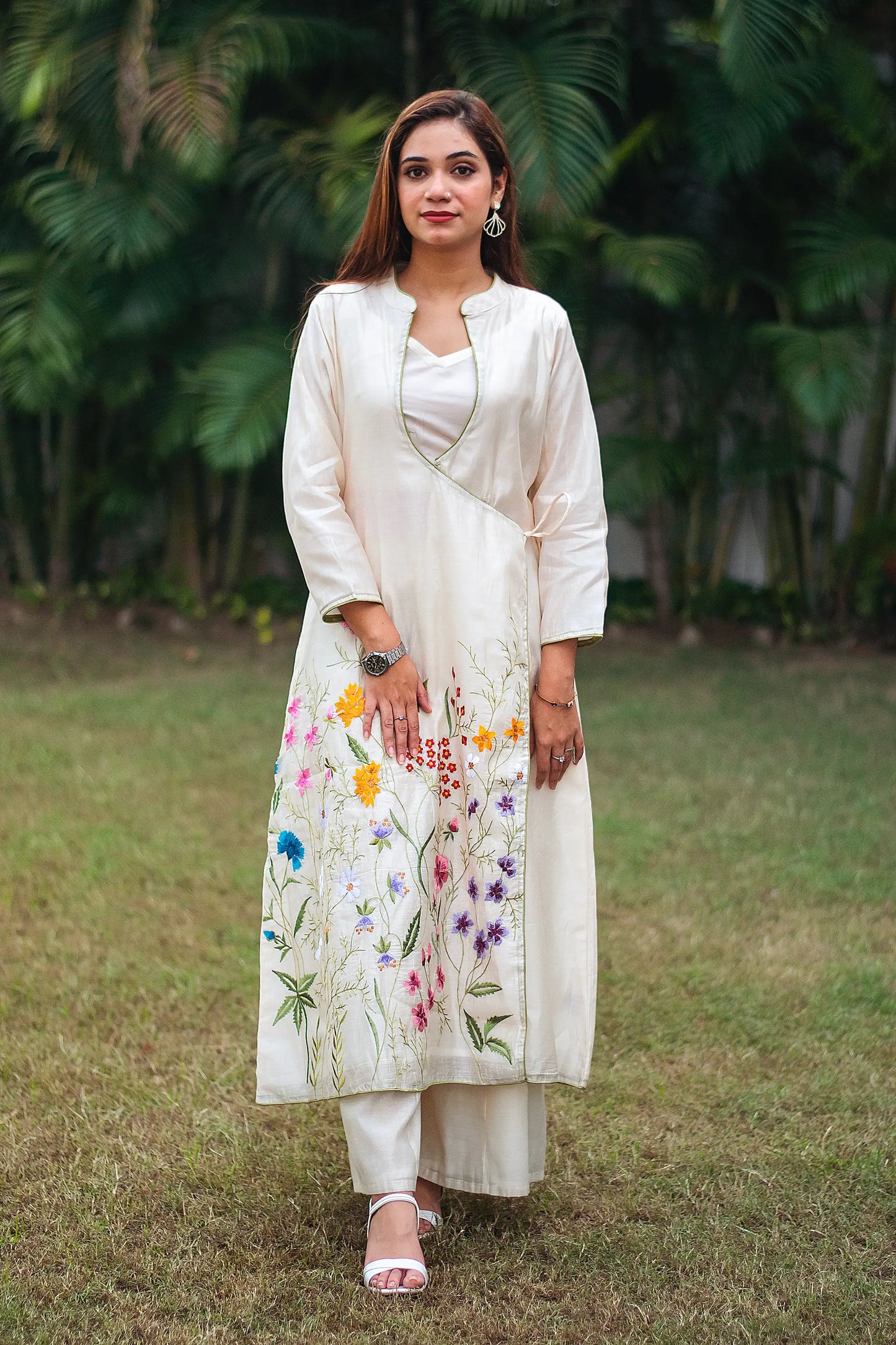 Indian model in an off-white angrakhawith vibrant resham embroidery, paired with matching palazzo.