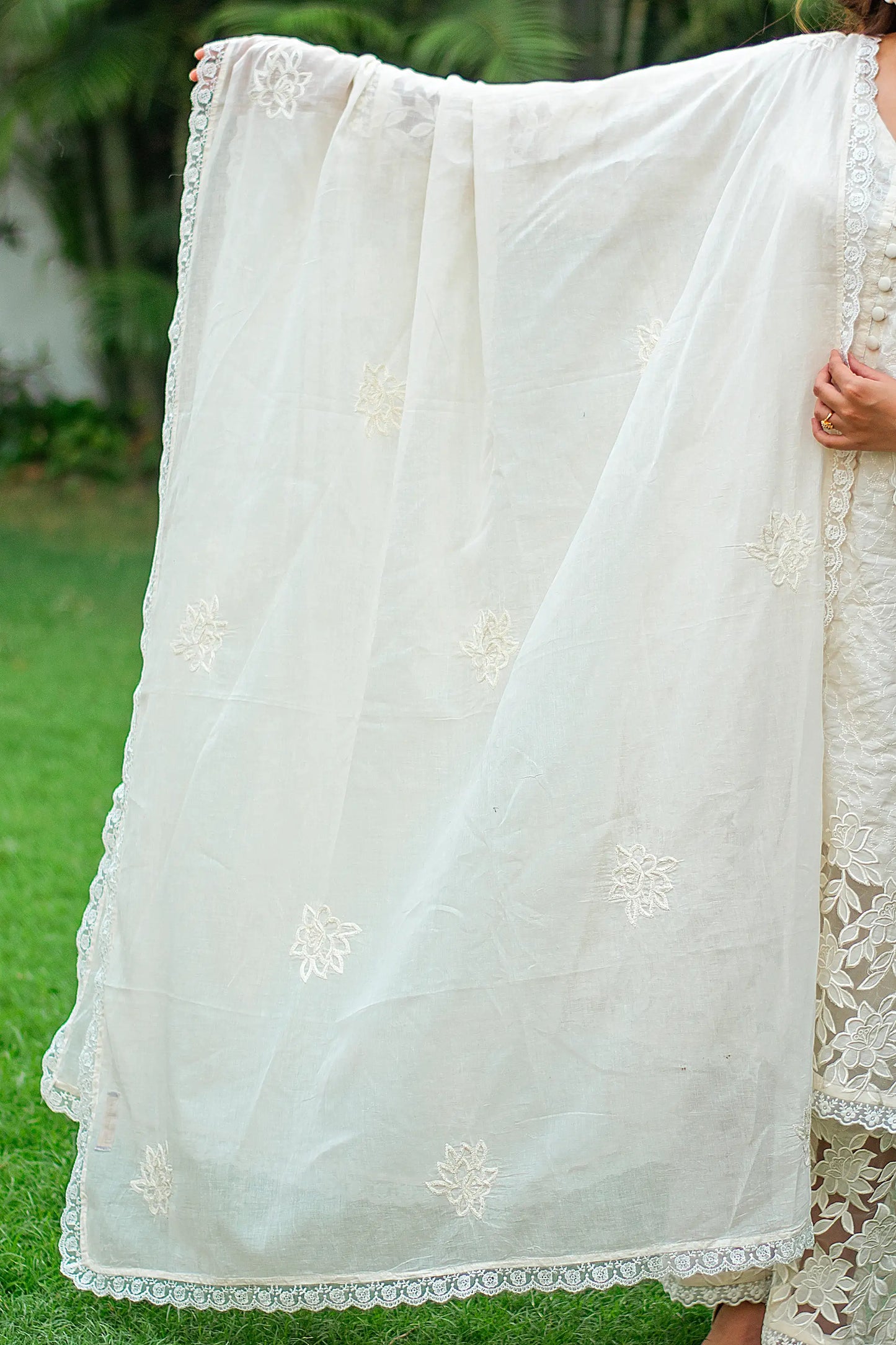 Indian model showcasing a white cotton dupatta with floral embroidery.