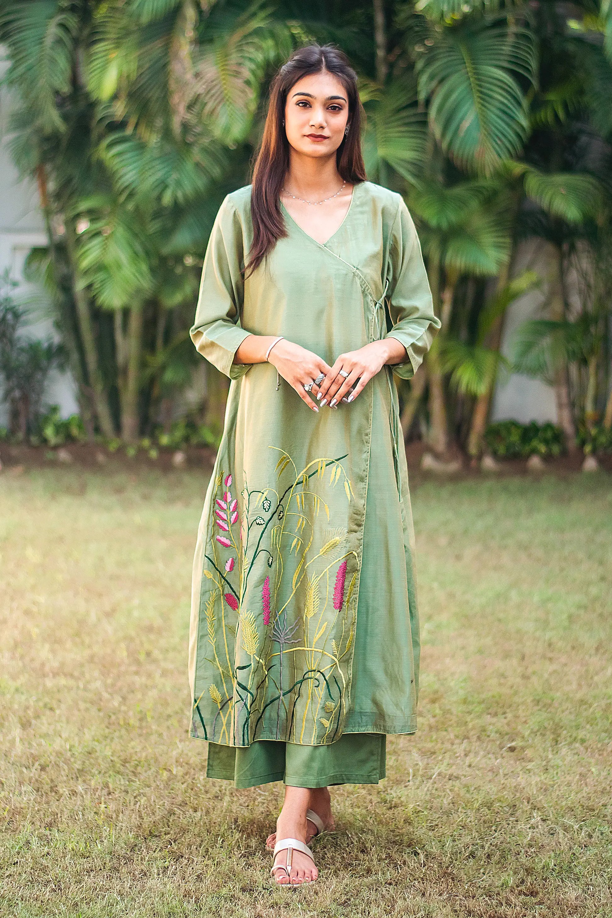 Front view of a model wearing the green kurta set, featuring green chanderi angarkha with multicolour floral embroidery and green palazzo.