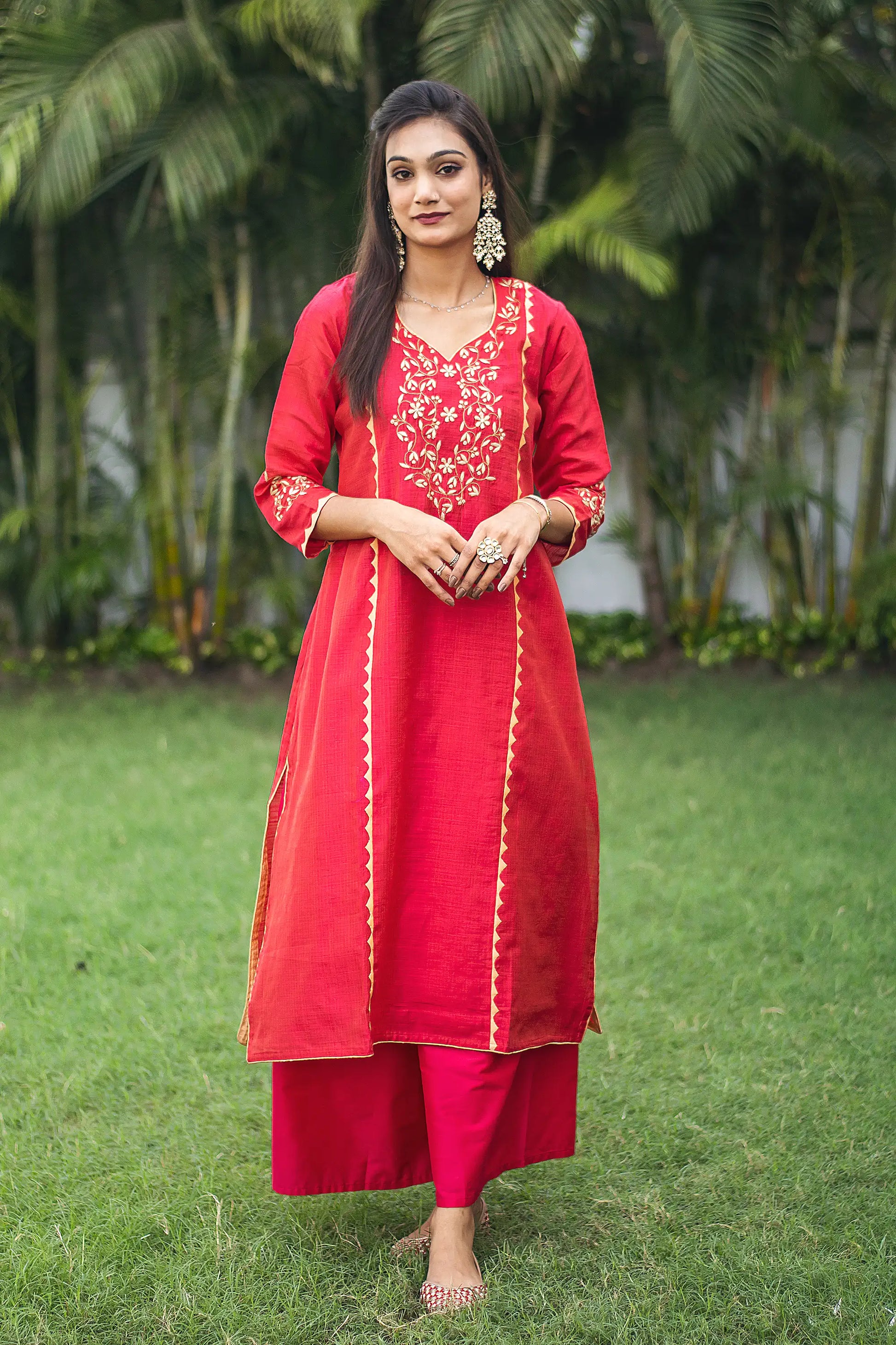 Indian model in a red jute silk kalidar  kurta with beige applique work and a red palazzo