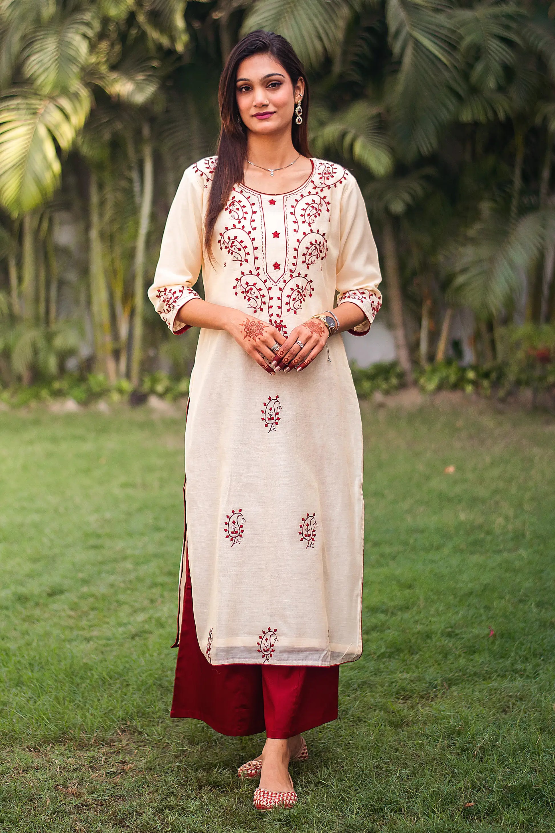 Indian model in a beige chanderi kurta with maroon paisley applique work, paired with a maroon palazz.