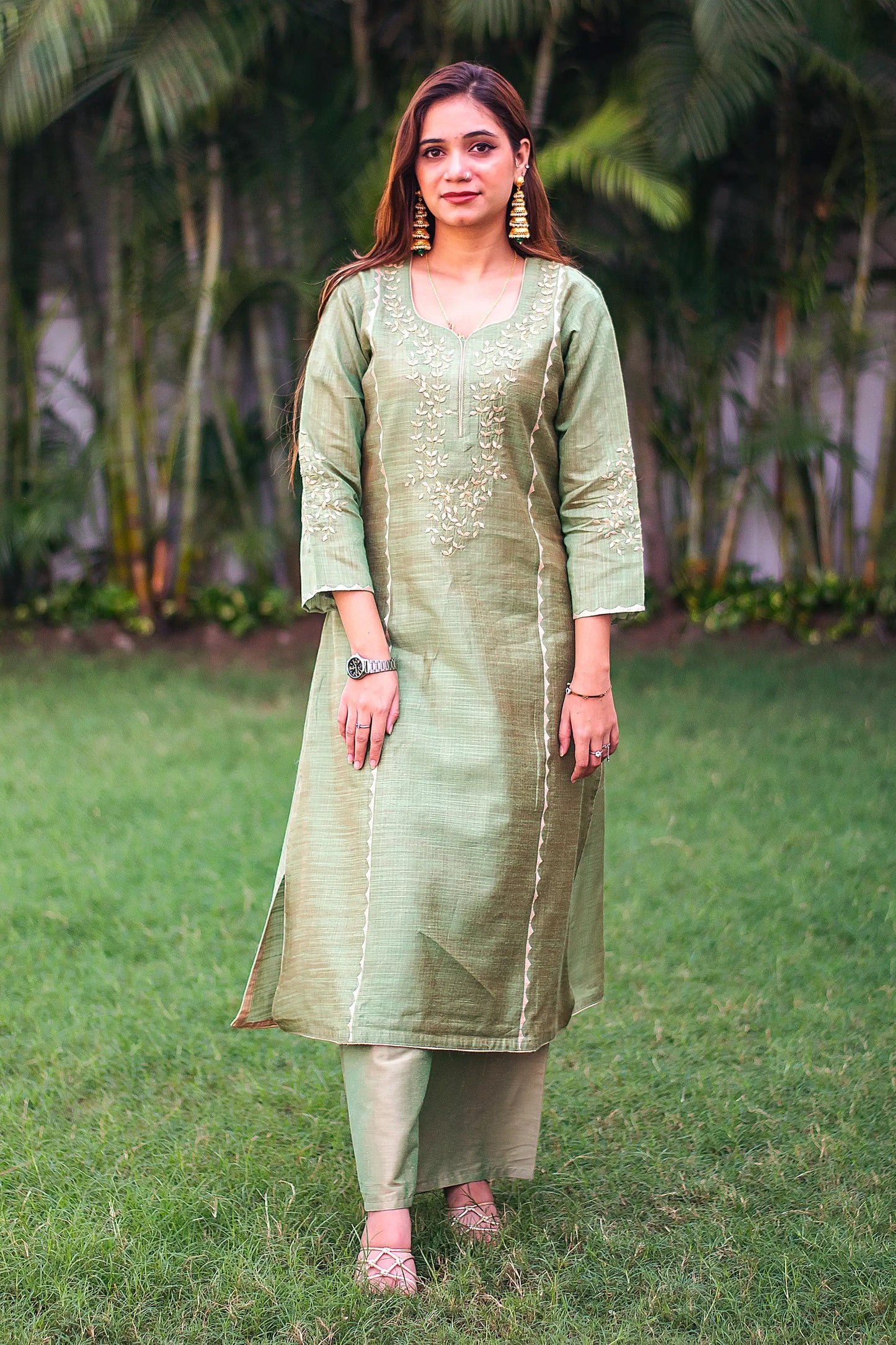 Indian model in a green jute silk kalidar kurta with beige applique work and a green palazzo.