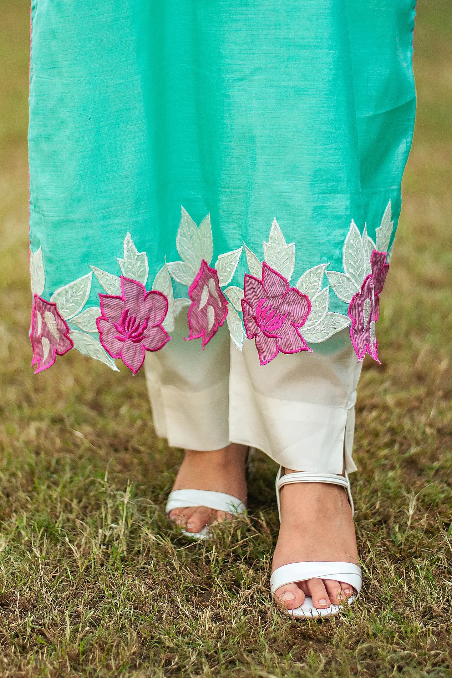 Close-up of off-white tussar trousers, worn with a blue chanderi kurta by an Indian model.