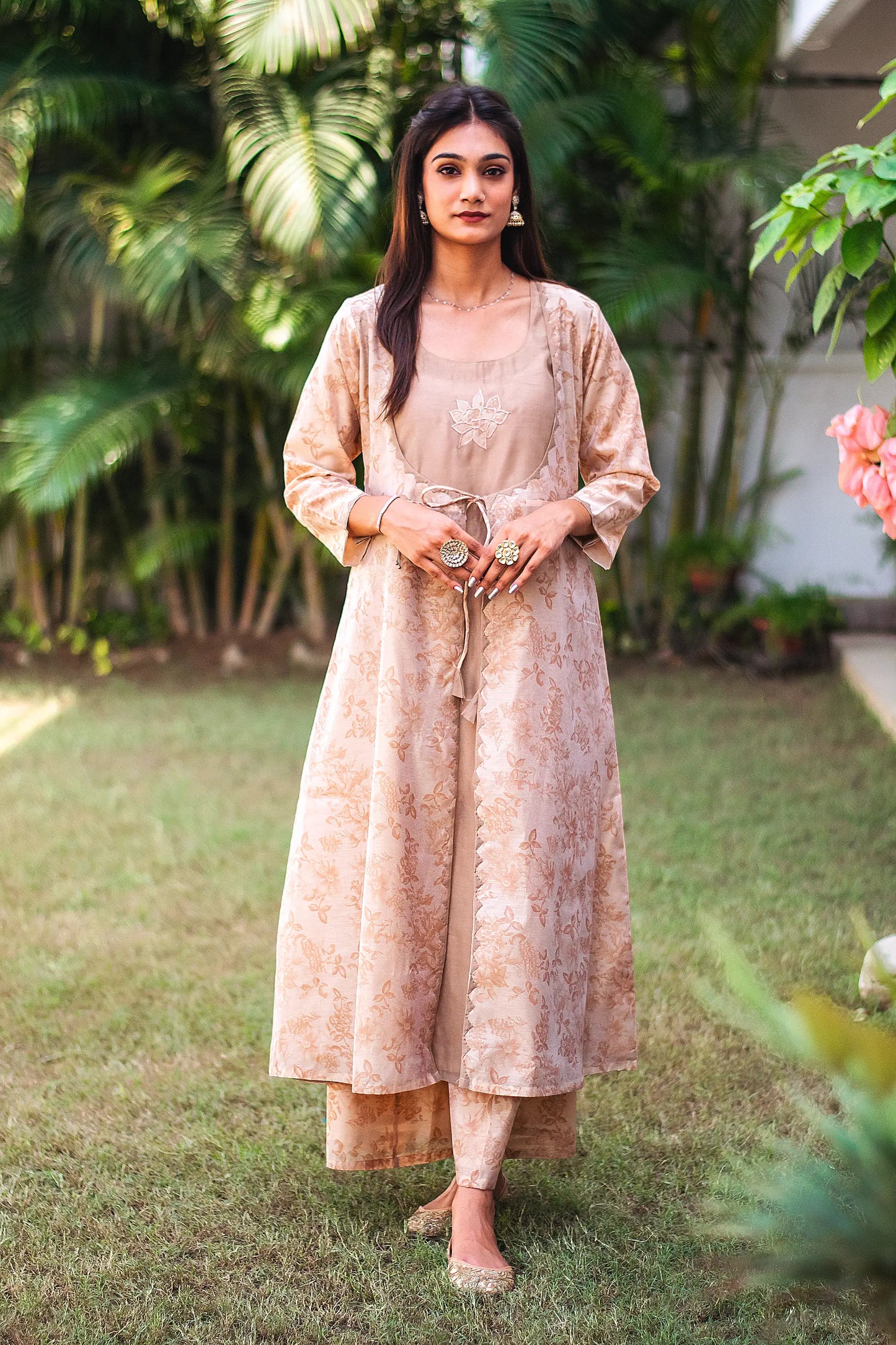 Front view of a model wearing the beige floral print kurta set, featuring a beige floral print chanderi angrakha, matching palazzo