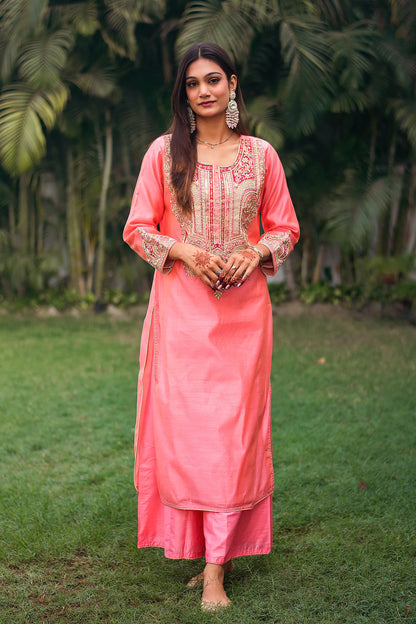 Indian model in a peach chanderi kurta with zardozi work, paired with a matching peach palazzo.