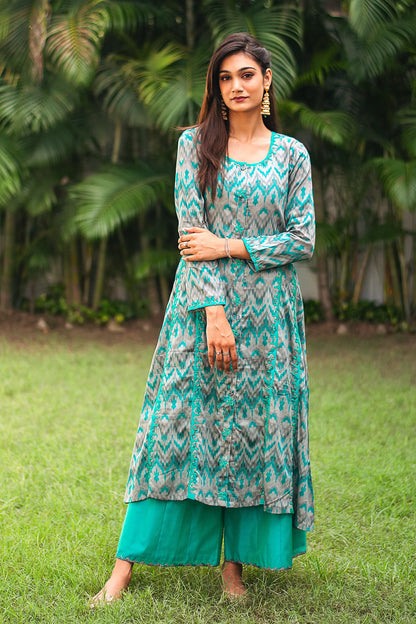 Indian model in a grey and green ikat print kurta with green applique motifs, paired with matching green palazzo.