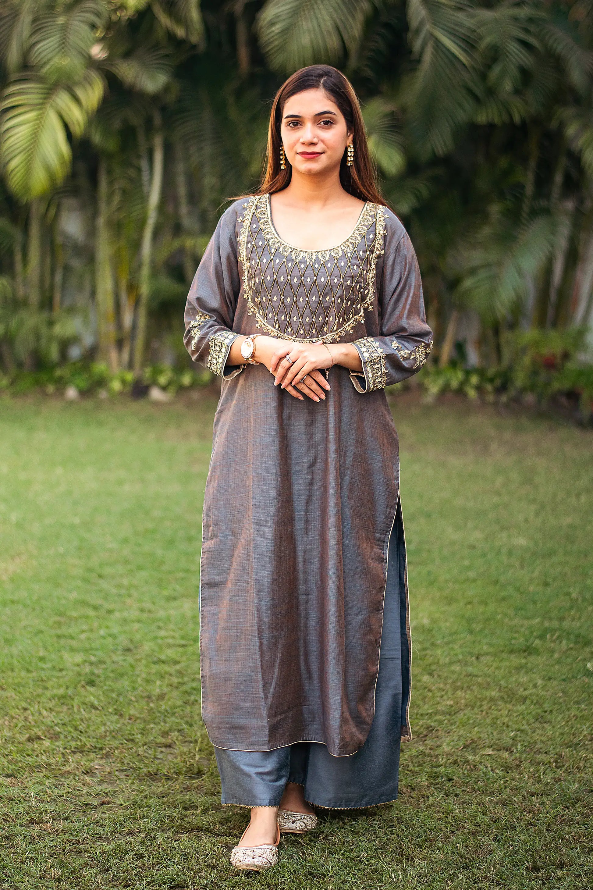 ndian model in a grey silk kurta with golden zardozi work, paired with matching grey cotton silk palazzo.