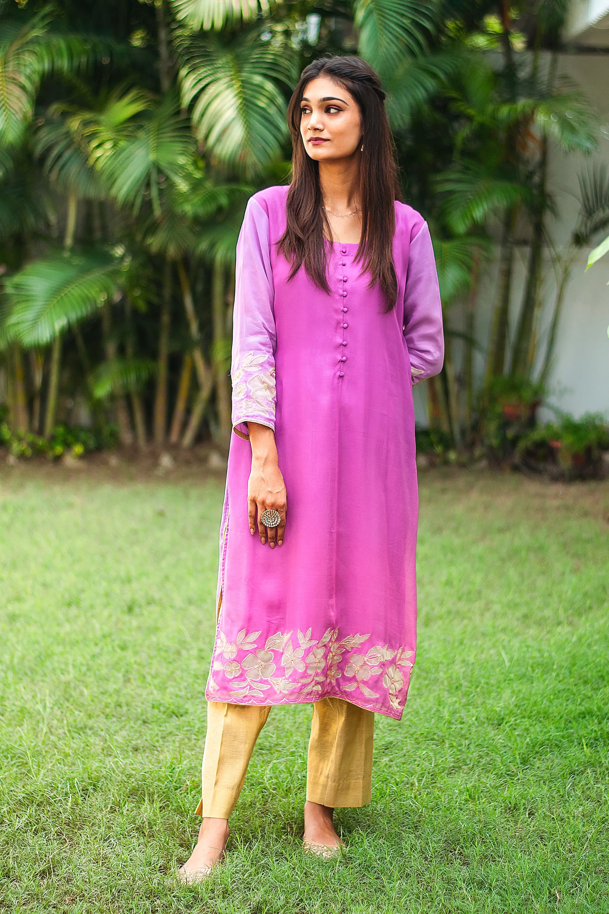 Indian model wearing a light purple organza kurta with golden floral cutwork, paired with gold trousers.